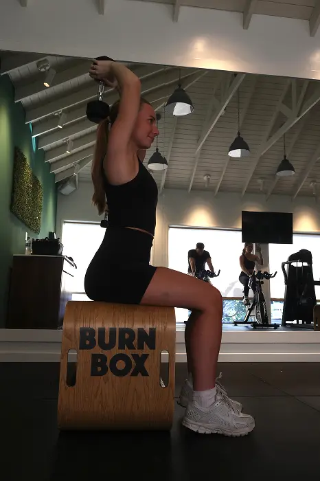 Guest working out at BurnBox Fitness center at Reef Haven Belize all-inclusive resor